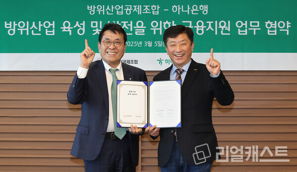 이날 협약식에 참석한 김진우 하나은행 중앙영업그룹 부행장(사진 왼쪽)이 김희철 방위산업공제조합 상근부이사장(사진 오른쪽)과 협약서를 들고 기념촬영을 하고 있다. 출처 : 하나은행