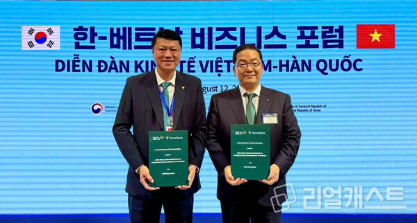 하나은행 이호성 은행장이(사진 오른쪽) 레 응옥 람 베트남투자개발은행장(사진 왼쪽)과 함께 협약서를 들고 기념촬영을 하고 있다(제공: 하나은행)